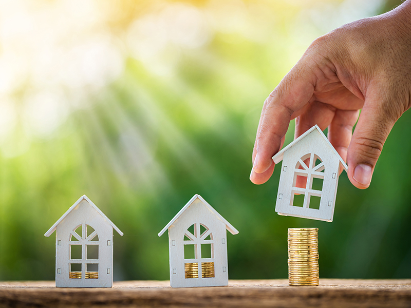 3 miniature house with coins inside